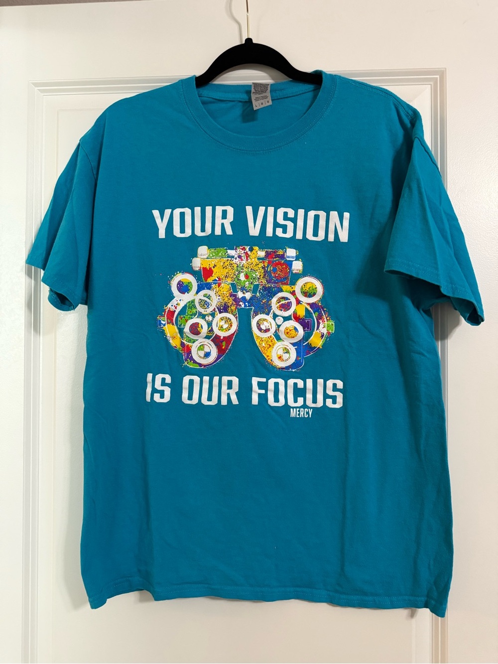 Mercy Nurse Graphic Teal Tee "Your Vision Is Our Focus"